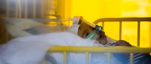 Ein Kind liegt mit einem Atemwegsinfekt auf einer Intensivstation.