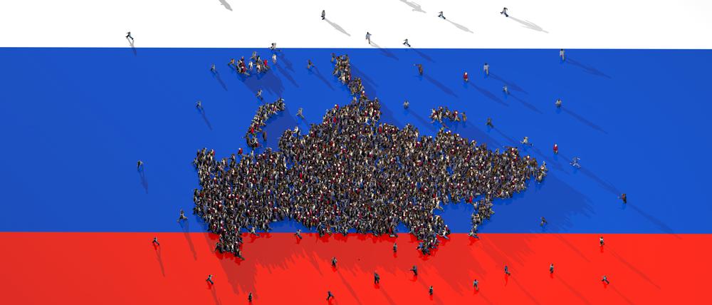 Large group of people forming Russia map on Russian Flag