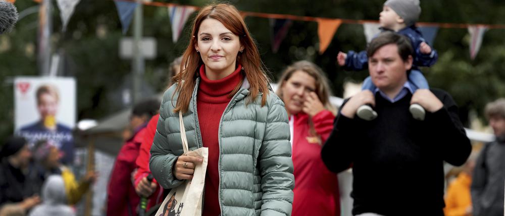 Ana-Maria Trasnea, front, candidate of the German Social Democrats for the federal elections walks on a street party in her election district in Berlin, Germany, Saturday, Sept. 18, 2021. (AP Photo/Michael Sohn)