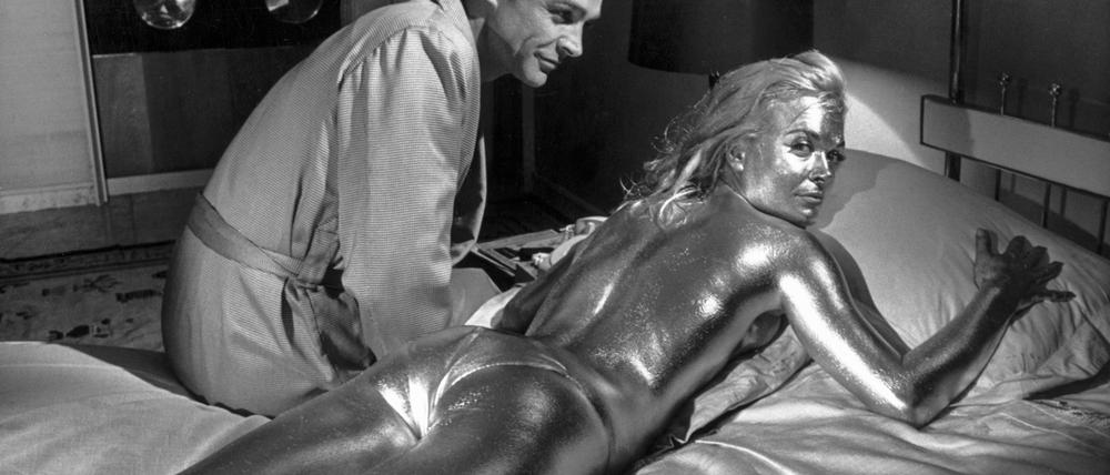 Der Schauspieler Sean Connery in der Rolle des James Bond und die goldüberzogene Shirley Eaton in „Goldfinger“ im Jahre 1964.