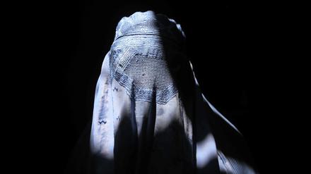An Afghan woman wearing a traditional burkha