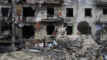 Ein ukrainischer Soldat zeigt in einem Videotelefonat ein durch russische Lufttechnik zerstörtes Haus.
