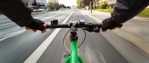 Cyclist drives on the bike path to a red traffic light - First-person view of cyclist/ motion blur