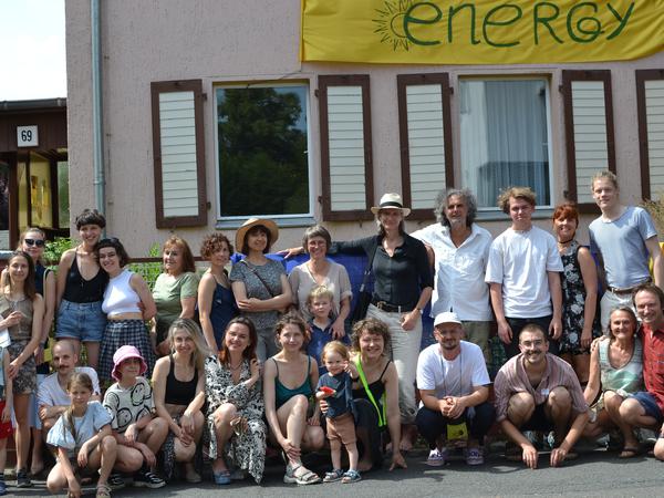 Künstler:innen aus der Ukraine, Aktive des Vereins Compango und Bezirksstadtrat Oliver Schruoffeneger bei der Einweihung des „Green Energy House“ in Eichkamp. 
