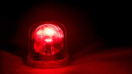 Emergency rotating alarm red light at night.
