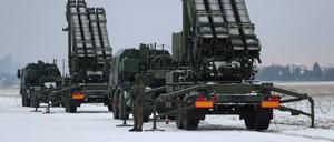 FILE PHOTO: Serviceman patrols in front of the Patriot air defence system during Polish military training on the missile systems at the airport in Warsaw, Poland February 7, 2023. REUTERS/Kacper Pempel/File Photo