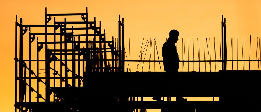 Ein Bauarbeiter geht auf einer Baustelle für ein Gebäude in Hannover.