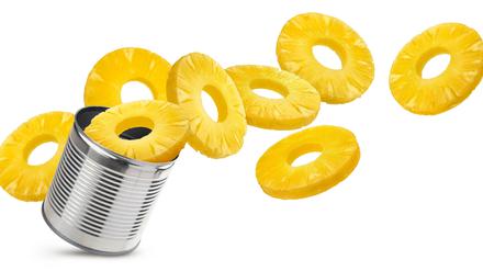 Canned pineapple rings isolated on white background.