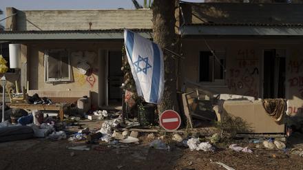 Eine israelische Flagge hängt im Kibbuz Kfar Azza in der Nähe des Gazastreifens zwischen zerstörten Häusern. 