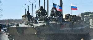 Militärfahrzeuge zeigen Flaggen der Volksrepublik Donezk und Russlands auf der Straße zwischen Volnovakha und Dokuchayevsk.