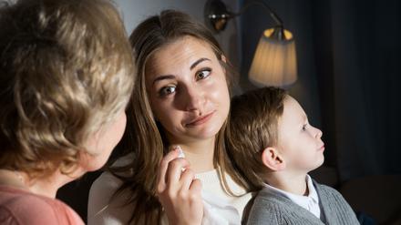 Aged woman is comforting emotional daughter after watching film at home.