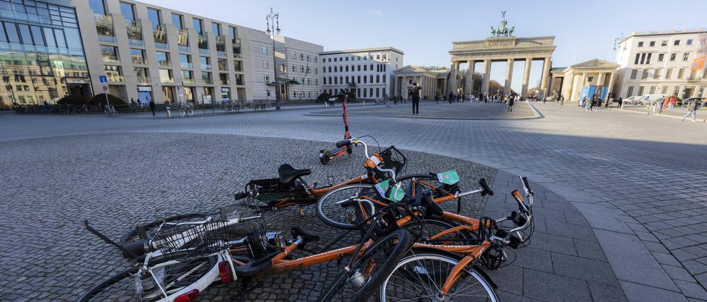 Leihfahrraeder liegen auf einem Haufen vor dem Brandenburger Tor in Berlin.