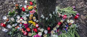Blumen und Kerzen haben Unbekannte an einem Baum im Bürgerpark Pankow abgelegt. Dort hatte eine Passantin zwischen Sträuchern die vermisste fünfjährige Anissa schwer verletzt gefunden. 