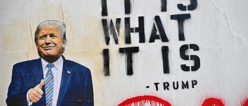 Street art picturing President Donald Trump and a phrase reading 'It IsWhat It Is' seen on October 2, 2020 in the Brooklyn borough of New York City. (Photo by Angela Weiss / AFP)